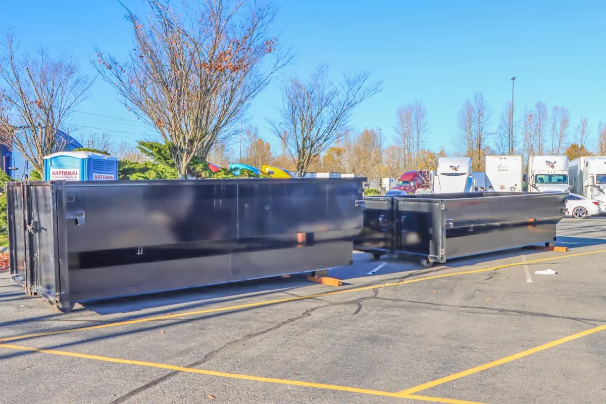 Professional dumpster rental service with roll-off container on residential driveway in Withamsville